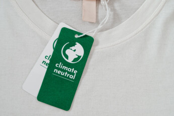 Carbon neutral t-shirt, Label Climate neutral on new clothes. Carbon neutral label concept in apparel, fashion industry. Ethical consumption.Increasing awareness for customers - carbon footpint