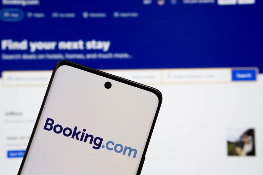 Dhaka, Bangladesh- 05 March 2025: Booking.com logo is displayed on a smartphone screen, with the booking.com website visible on a computer screen in the background. Dhaka, Bangladesh- 05 March 2025: Booking.com logo is displayed on a smartphone screen, with the booking.com website visible on a computer screen in the background. Copyright: xZoonar.com/MojahidxMottakinx 23049678