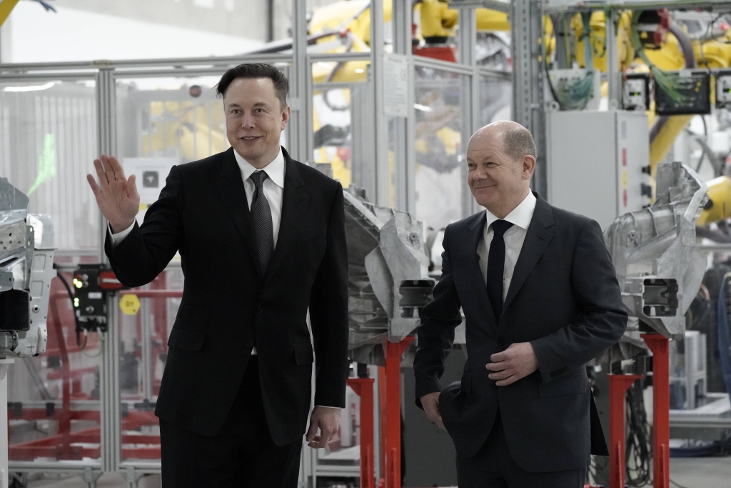 Elon Musk und Ex-Bundeskanzler Olaf Scholz im Jahr 2022 in Teslas Gigafactory in Grünheide (Credit: 
Imago / Political-Moments).