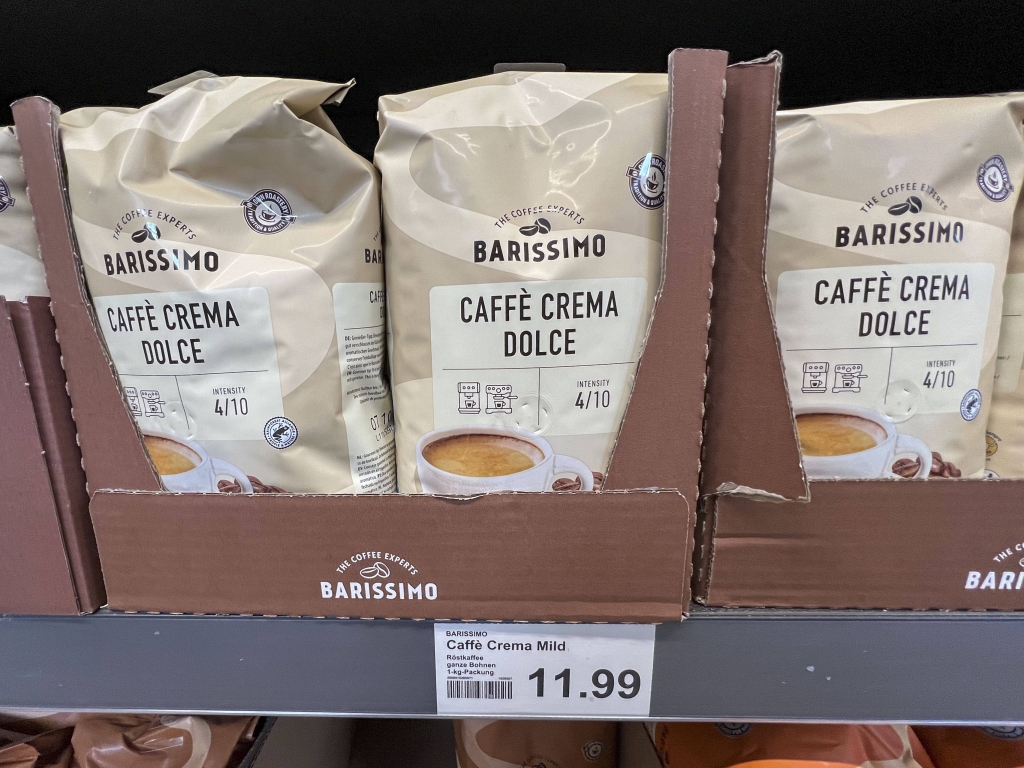 Regal mit Tueten Cafe Crena Dolce zum Preis per KG 11,99 Euro roestfrischen, hochwertigen Arabica Hochlandkaffee Kaffee als Bohnen Packungen der eigenmark Barissimo beim Discounter Aldi Nord Hamburg Deutschland *** Shelf with bags Cafe Crena Dolce at a price per KG 11,99 Euro roestfresh, high-quality Arabica highland coffee as beans packs of the own brand Barissimo at the discounter Aldi Nord Hamburg Germany